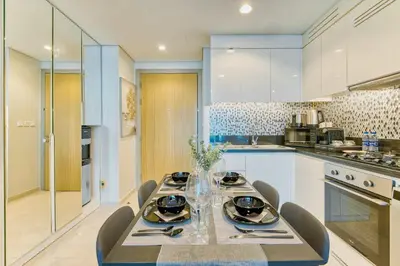 a kitchen with a dining table and chairs at PVH - City View Contemporary 2BR - Aykon Tower C in Dubai
