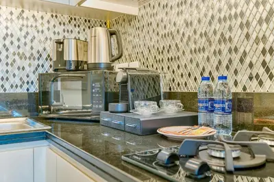 a kitchen with a counter top with bottles of water at PVH - City View Contemporary 2BR - Aykon Tower C in Dubai