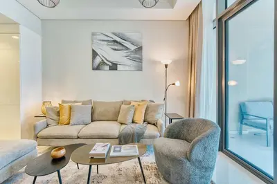 a living room with a couch and a chair at PVH - City View Contemporary 2BR - Aykon Tower C in Dubai