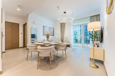 a dining room with a table and chairs at Balcony Facing a Partial Canal View, Close to Metro and Marine Transport, Downtown Attractions Just a Ride Away, Urban Oasis, Business Bay by Deluxe Holiday Homes in Dubai