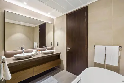 a bathroom with two sinks and a large mirror at Modern 1BR in Dubai Marina near to Dubai Harbour in Dubai