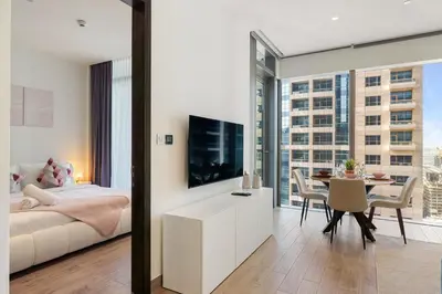 a bedroom with a bed and a dining room with a table at Modern 1BR in Dubai Marina near to Dubai Harbour in Dubai