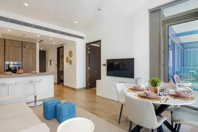 a dining room and kitchen with a table and chairs at Modern 1BR in Dubai Marina near to Dubai Harbour in Dubai