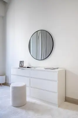 a white dresser with a mirror on a wall at Frank Porter - Grove at Creek Beach Building in Dubai