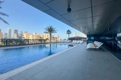 a swimming pool on a building with a view of a city at Frank Porter - Ocean Heights, Dubai Marina in Dubai