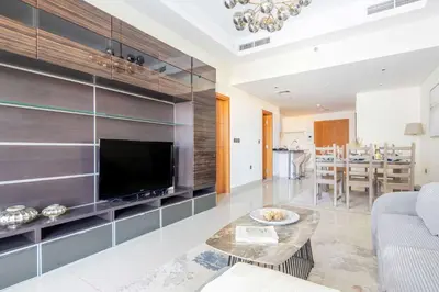 a living room with a tv and a couch and a table at Frank Porter - Ocean Heights, Dubai Marina in Dubai