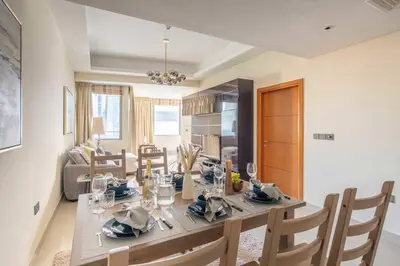 a kitchen and dining room with a table and chairs at Frank Porter - Ocean Heights, Dubai Marina in Dubai