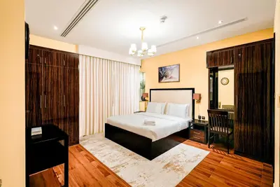 a bedroom with a bed and a desk in a room at Escape24 2BR with Large Balcony near Burj Khalifa in Dubai