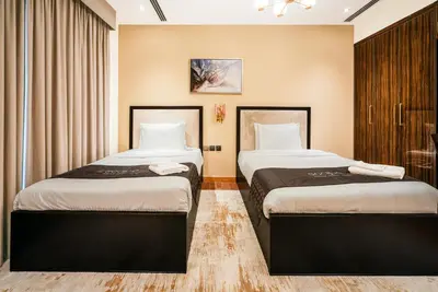a hotel room with two beds in a room at Escape24 2BR with Large Balcony near Burj Khalifa in Dubai
