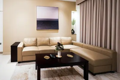 a living room with a couch and a table at Escape24 2BR with Large Balcony near Burj Khalifa in Dubai