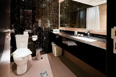 a black bathroom with a toilet and a sink at Escape24 2BR with Large Balcony near Burj Khalifa in Dubai