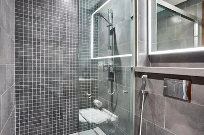 a bathroom with a glass shower with a toilet at The Crest C Luxury Retreat Stylish & Serene in Dubai