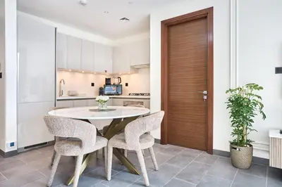 a kitchen and dining room with a table and chairs at The Crest C Luxury Retreat Stylish & Serene in Dubai