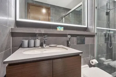 a bathroom with a sink and a shower at The Crest C Luxury Retreat Stylish & Serene in Dubai