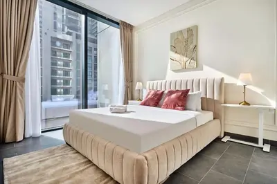 a bedroom with a large white bed and a window at The Crest C Luxury Retreat Stylish & Serene in Dubai
