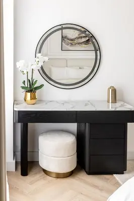 a black dressing table with a mirror and a stool at Stylish 1 Bedroom Apartment with Marina View JBR in Dubai