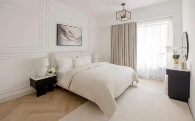 a white bedroom with a bed and a window at Stylish 1 Bedroom Apartment with Marina View JBR in Dubai