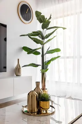 a table with a vase and a plant on it at Stylish 1 Bedroom Apartment with Marina View JBR in Dubai