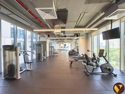 a gym with treadmills and ellipticals in a building at Vogue Creek Harbour Icon Bay Waterfront Living Close to Downtown, Burj Khalifa and Dubai Mall, Two Bedroom Apartment with Large Balcony and Canal View, Access to all Amenities in Dubai