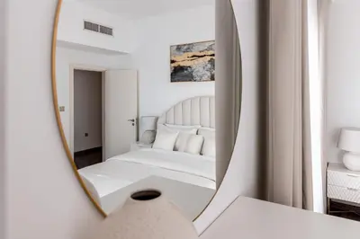 a mirror reflection of a bed in a bedroom at Beautiful 2 bed in JBR! bahar in Dubai