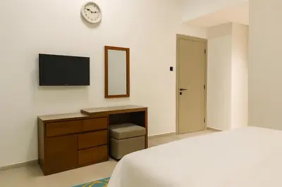 a bedroom with a bed and a desk and a tv at City Stay Dubai South - Serviced Apartments in Dubai