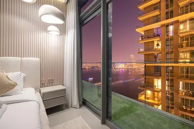 a bedroom with a large window with a view of the city at Serene Beachfront Oasis Private Beach 4BR in Dubai