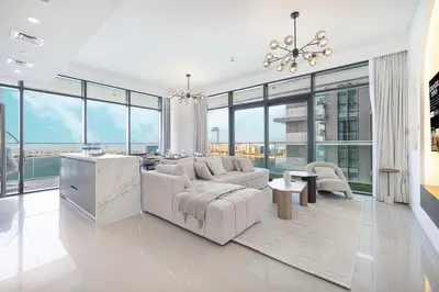 a living room with a couch and a table at Serene Beachfront Oasis Private Beach 4BR in Dubai