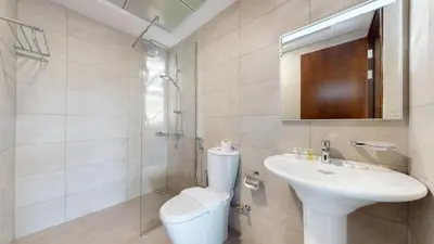 a bathroom with a sink and a toilet and a mirror at Locations l Peaceful 2 Bedroom l Community Views l Free Pool, Gym Access in Dubai