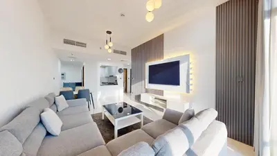 a living room with a couch and a tv at Locations l Peaceful 2 Bedroom l Community Views l Free Pool, Gym Access in Dubai