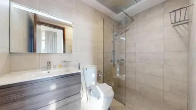 a bathroom with a toilet and a sink and a shower at Locations l Peaceful 2 Bedroom l Community Views l Free Pool, Gym Access in Dubai