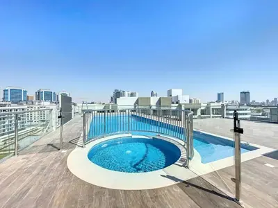 a hot tub on the roof of a building at Locations l Peaceful 2 Bedroom l Community Views l Free Pool, Gym Access in Dubai