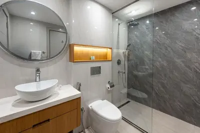 a bathroom with a toilet and a sink and a shower at 1 BR Near Burj Khalifa & Dubai Mall - Downtown in Dubai