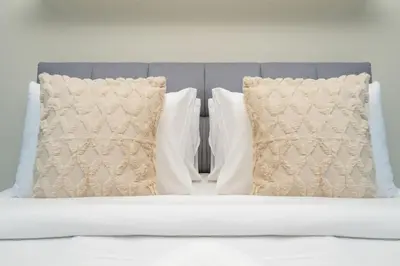 two pillows sitting on top of a bed at Spacious 2-Bed Marina Home with Wrap-Around Balcony in Dubai