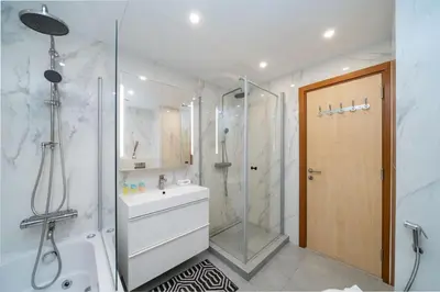a bathroom with a shower and a sink at Spacious 2-Bed Marina Home with Wrap-Around Balcony in Dubai