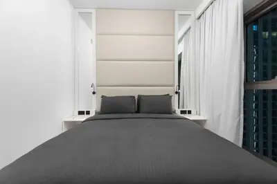 a bedroom with a large bed with two pillows at The Iconic View - 3BR With Maid's Room - Burj Khalifa Area in Dubai