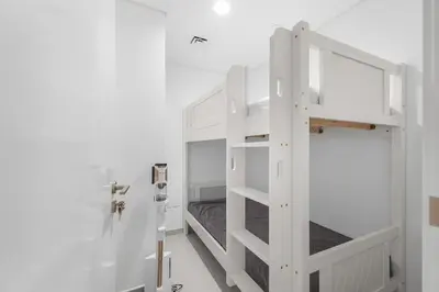 a white bunk bed in a white room at The Iconic View - 3BR With Maid's Room - Burj Khalifa Area in Dubai