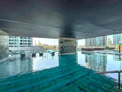 a swimming pool on the top of a building at Luxurious High-Floor 3BR with Assistant Room, Showcasing Lake & City Views, Just Moments Drive from JBR Beaches and Ain Dubai, MBL Royal, JLT by Deluxe Holiday Homes in Dubai