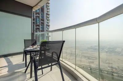 a table and chairs on the balcony of a building at Frank Porter - Paramount Tower A in Dubai