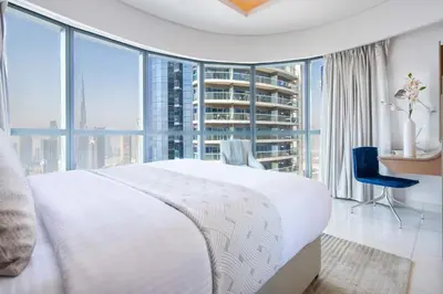 a bedroom with a large white bed and large windows at Frank Porter - Paramount Tower A in Dubai