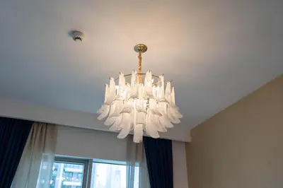 a large white chandelier hanging from a ceiling at Luxury 1BR with Private Beach & Pool! in Dubai