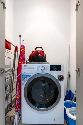 a washing machine with a purse on top of it at Luxury 1BR with Private Beach & Pool! in Dubai