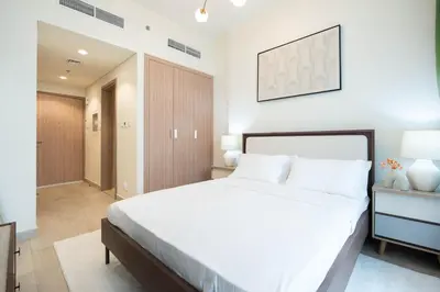 a bedroom with a large white bed in a room at Modern Studio in Azizi Riviera 46 with Pool, Gym & Free Parking in Dubai