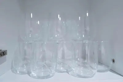 a group of empty glasses sitting on a counter at Modern Studio in Azizi Riviera 46 with Pool, Gym & Free Parking in Dubai