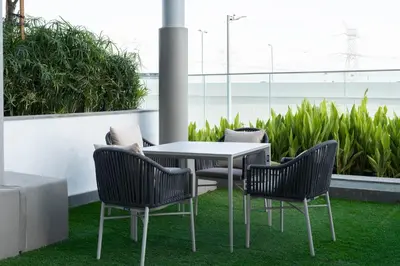 a table and two chairs and a table and chairs at Modern Studio in Azizi Riviera 46 with Pool, Gym & Free Parking in Dubai