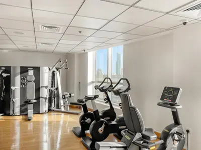 a gym with treadmills and exercise bikes in a room at FIRST CLASS 1BR Scenic Marina Views in Dubai