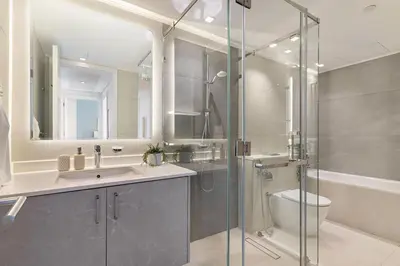 a bathroom with a shower and a sink and a toilet at The Smart Concierge - Marina tower in Dubai