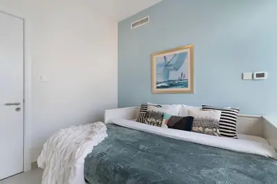 a bedroom with a large bed with pillows on it at The Smart Concierge - Marina tower in Dubai