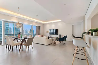 a living room with a couch and a table and chairs at The Smart Concierge - Marina tower in Dubai