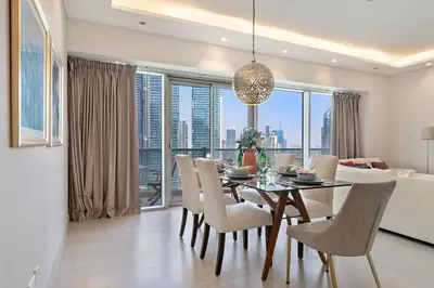 a dining room with a table and chairs with a view at The Smart Concierge - Marina tower in Dubai