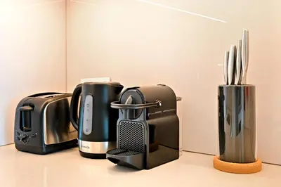 a group of coffeemakers sitting on a counter at New & Beautiful 1BD Apartment in Address JBR in Dubai